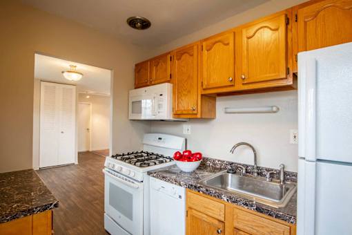 A kitchen with a stove, oven, refrigerator, and sink at Michigan Street Apartment Homes, Grand Rapids  , Michigan