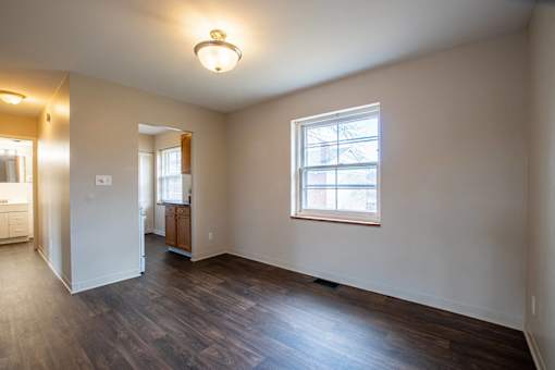 A room with a window and wooden floors  at Michigan Street Apartment Homes, Grand Rapids  , MI, 49503