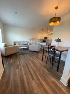 A living room with a white couch and a wooden floor at The Vue at Rivertown Park Townhomes, Wyoming  , 49418