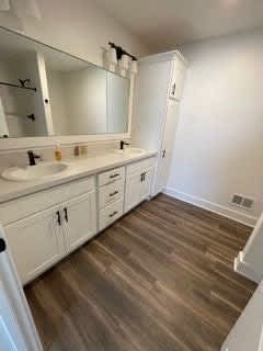 A bathroom with a white vanity and a large mirror at The Vue at Rivertown Park Townhomes, Apartments, Wyoming  , MI