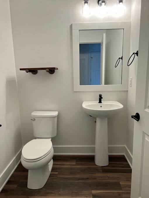 A white toilet and sink in a small bathroom at The Vue at Rivertown Park Townhomes, Wyoming  , 49418
