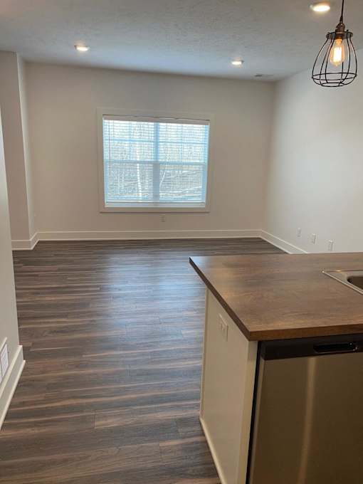 A kitchen with a wooden countertop and a dishwasher at The Vue at Rivertown Park Townhomes, Wyoming  