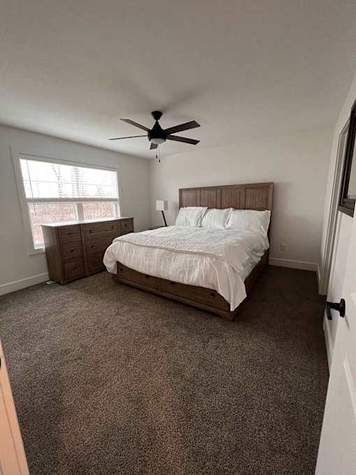 A bedroom with a bed, dresser at The Vue at Rivertown Park Townhomes, Michigan