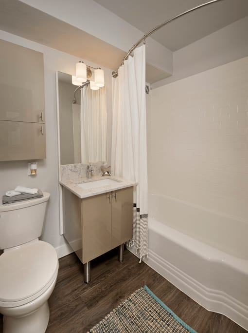 A white toilet sites next to a sink in a bathroom