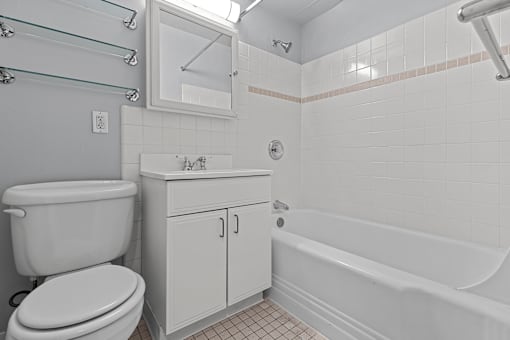 A white toilet sits next to a sink in a bathroom.