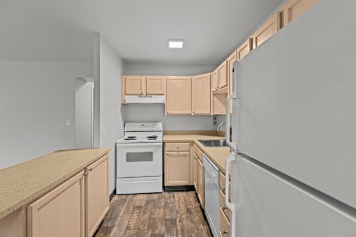 A kitchen with wooden cabinets and a white stove top oven