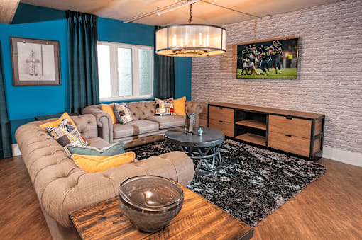 A living room with a grey sofa and a wooden coffee table