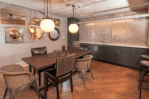 A dining room with a wooden table and chairs.