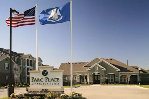 The Parc Place Apartment Homes sign is in front of a building.