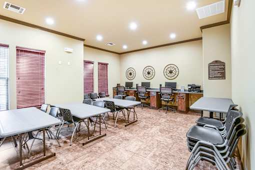 A conference room with a long table, chairs, and a plaque on the wall.