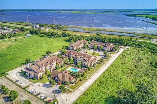 A bird's eye view of a residential area with houses and a swimming pool.
