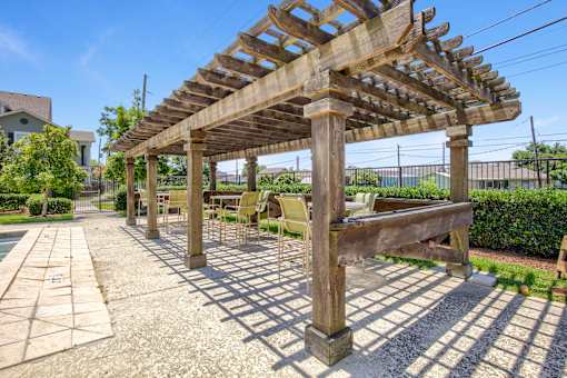 A wooden pergola with a bench underneath it.