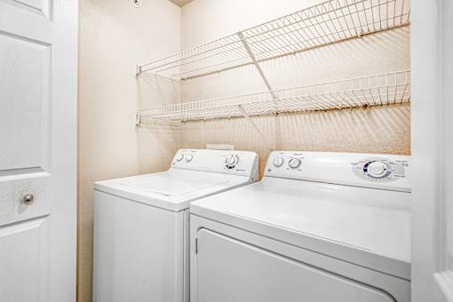 A white washer and dryer in a laundry room.