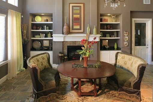A living room with a fireplace and a painting on the wall.