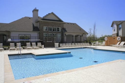 A large house with a pool in front.