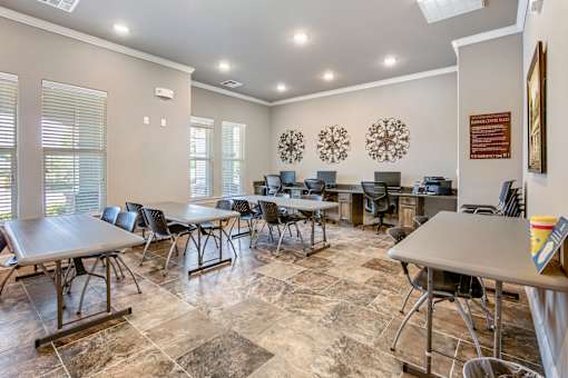 A conference room with a table and chairs.