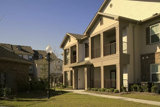 A row of houses with a clear blue sky above them.