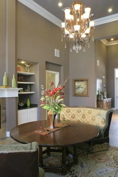 A dining room with a table and chairs.