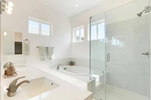 A white bathroom with a glass shower stall.