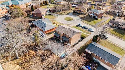 A bird's eye view of a residential area with houses and cars.