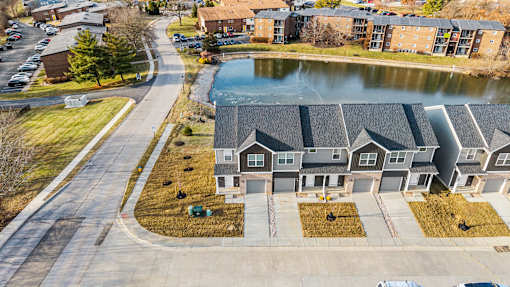 A residential area with a pond and houses.