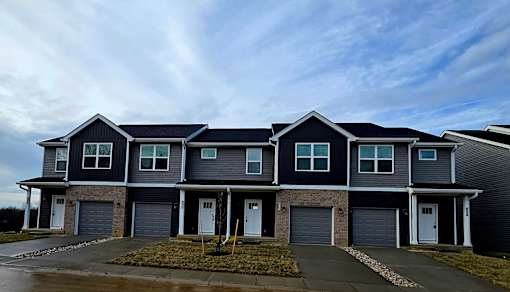 A row of houses with garages in front.