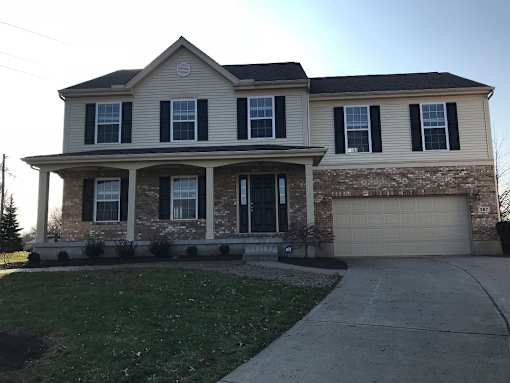 A house with a grey roof and a garage door.