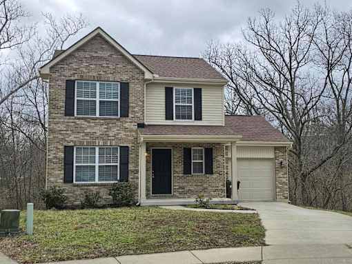 A two-story house with a garage on the side.