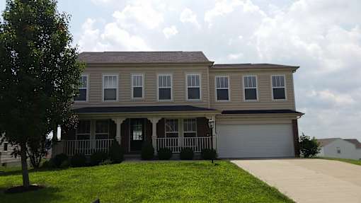 A two-story house with a garage on the right side.