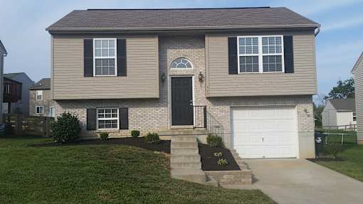 A house with a black door and a white garage door.