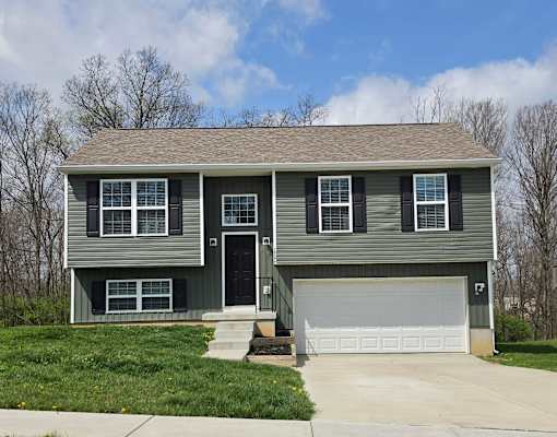 A two-story house with a garage door.