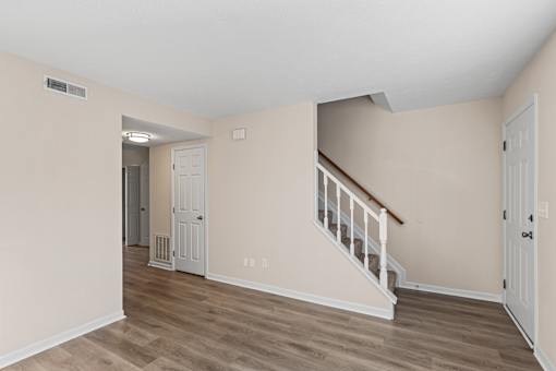 A room with a staircase and a door.