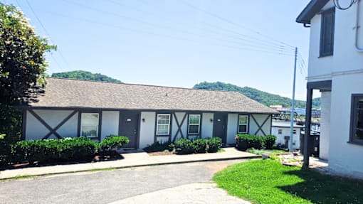 A white building with a grey roof and black trim.