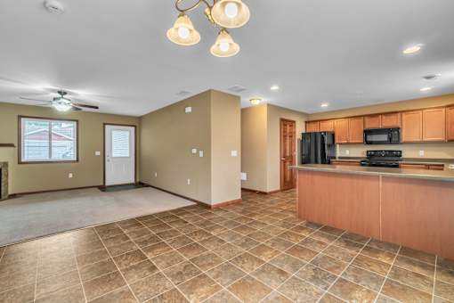 A kitchen area with a counter and a microwave.