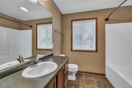A bathroom with a sink, toilet, and bathtub.