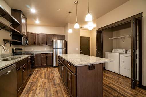 A kitchen with wooden floors and a white counter top.