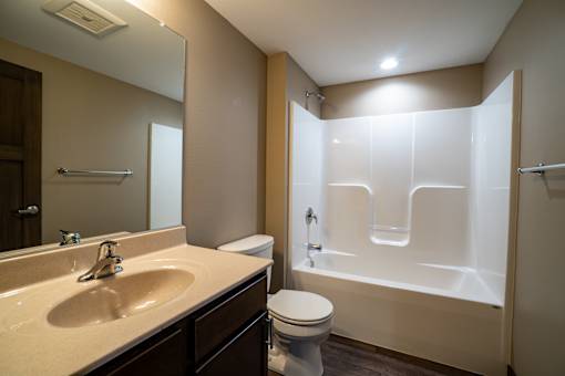 A bathroom with a sink, toilet, and bathtub.