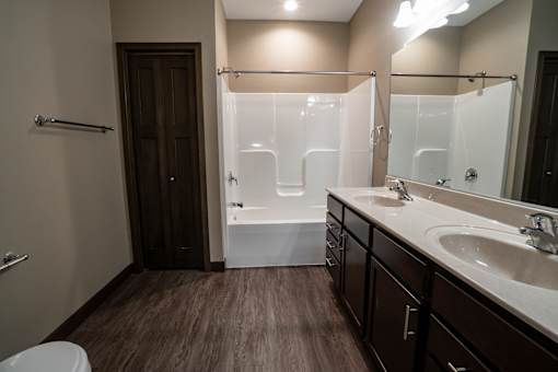 A bathroom with a toilet, sink, and shower.