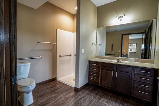A bathroom with a toilet, sink, and shower.