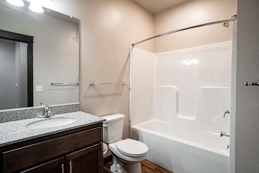 A bathroom with a toilet, sink, and bathtub.