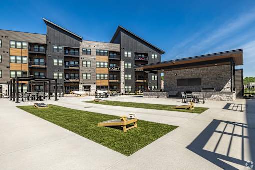 A modern building with a large open courtyard in front.