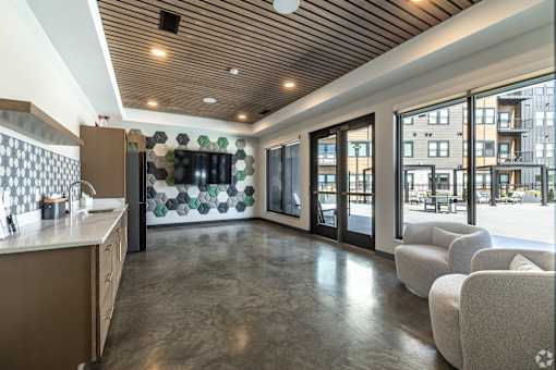 A modern kitchen with a wooden ceiling and a large island.
