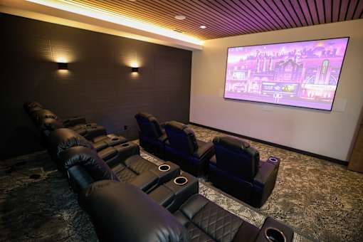 A home theater with a large screen and comfortable seating.