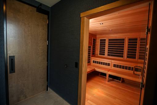 A room with a wooden bench and a wooden door.