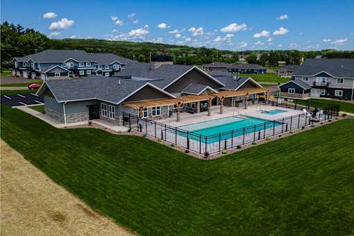 A large house with a pool in the backyard.