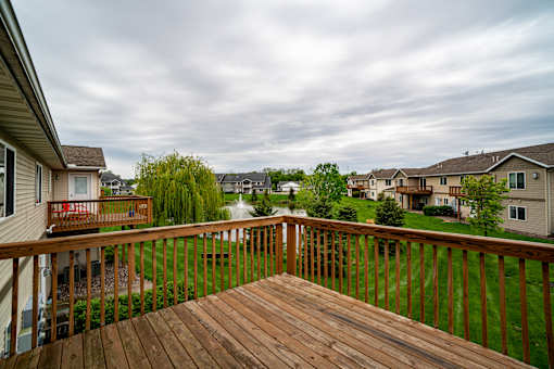 A wooden deck overlooks a residential neighborhood.