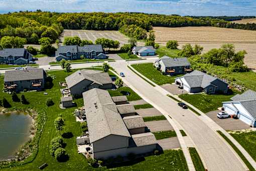 A suburban neighborhood with houses and a pond.