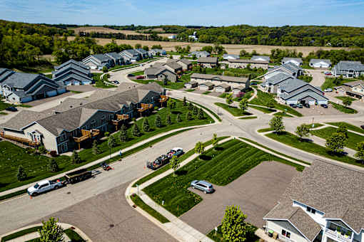 A suburban neighborhood with houses and cars.