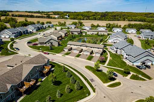 A bird's eye view of a residential neighborhood with houses and cars.