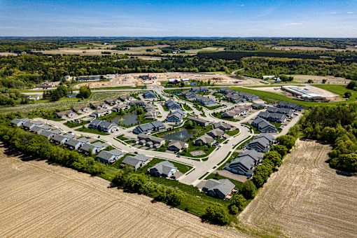 A bird's eye view of a residential area with houses and roads.
